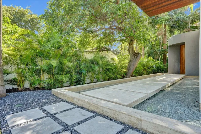 a living room with couch and a floor to ceiling window