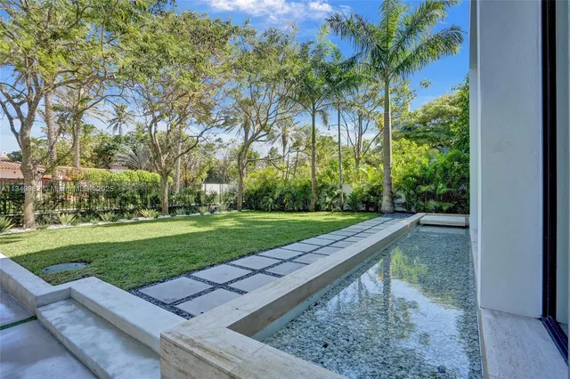 a view of a porch with chairs and backyard