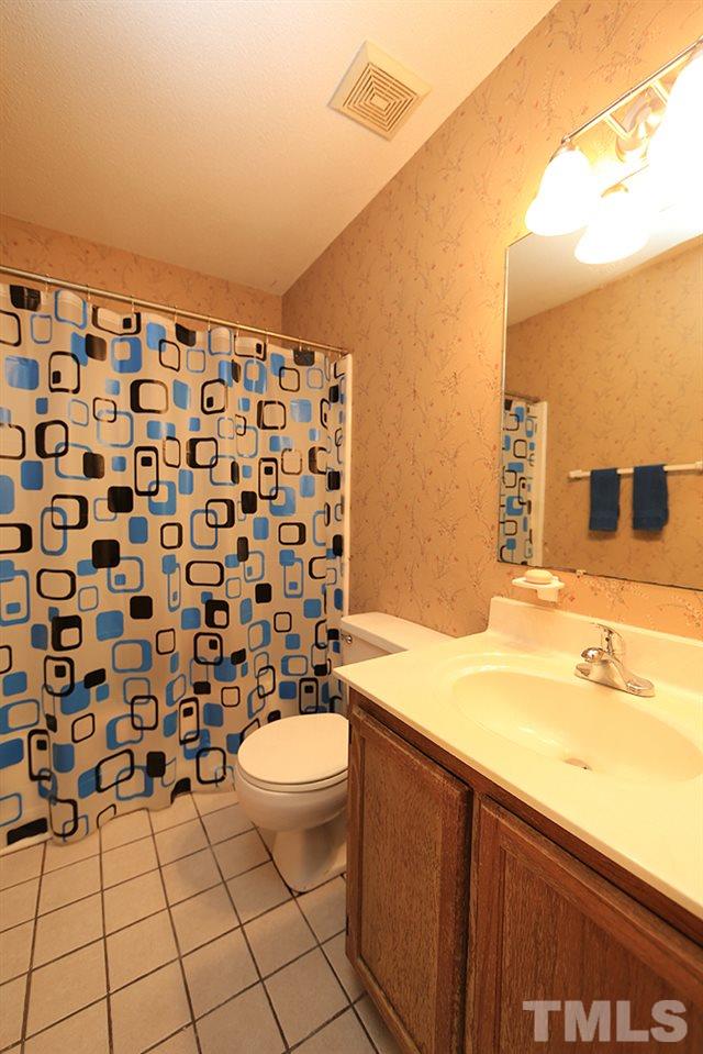 4509 Fox Road Raleigh, NC 27616 - Photo 11 of 13 a bathroom with a sink toilet and shower