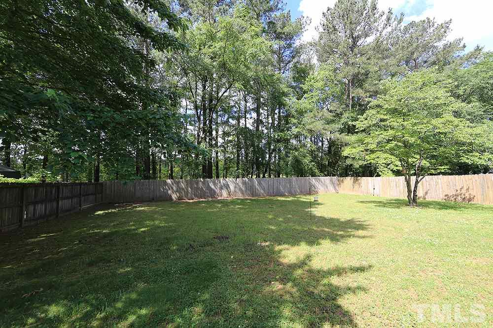 4509 Fox Road Raleigh, NC 27616 - Photo 12 of 13 a view of yard with swimming pool and trees in the background