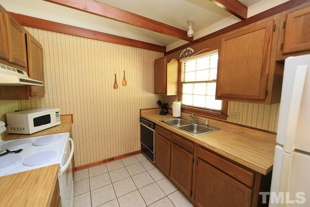 4509 Fox Road Raleigh, NC 27616 - Photo 6 of 13 a kitchen with stainless steel appliances granite countertop a sink stove and refrigerator