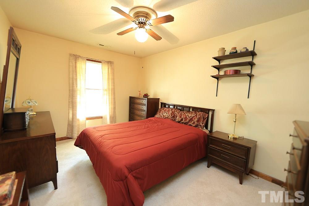 4509 Fox Road Raleigh, NC 27616 - Photo 9 of 13 a bedroom with a bed and wooden floor