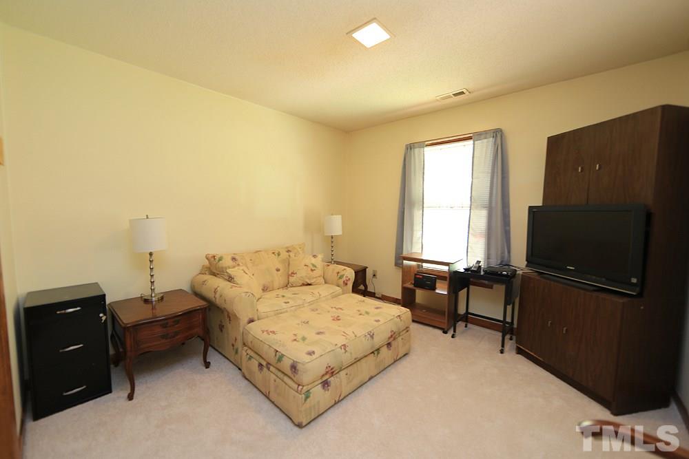 4509 Fox Road Raleigh, NC 27616 - Photo 10 of 13 a bedroom with a bed and furniture