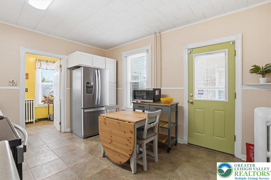525 Ridge Street Emmaus, PA 18049 - Photo 23 of 68 This cozy kitchen features practical appliances and a bright entryway, perfect for daily living.