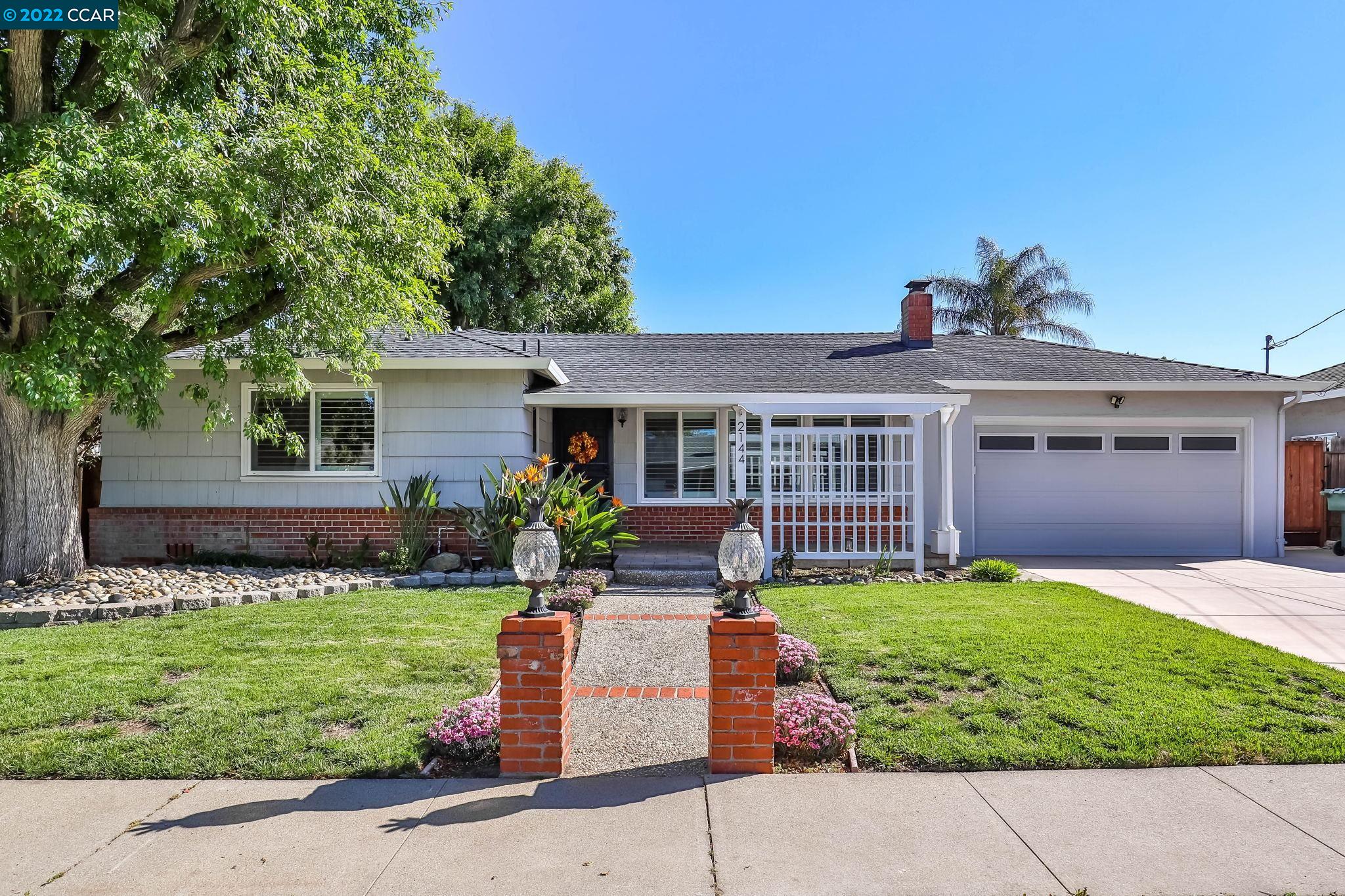 2144 Dena Drive Concord, CA 94519 - Photo 1 of 27 a front view of a house with a garden and yard