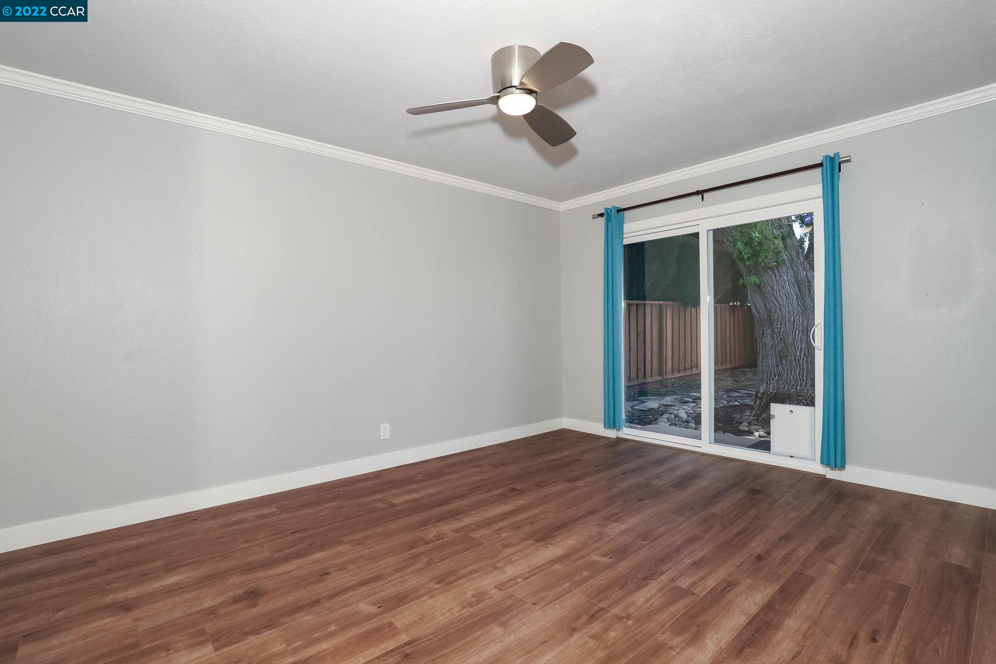 2144 Dena Drive Concord, CA 94519 - Photo 13 of 27 a view of an empty room with wooden floor and a window