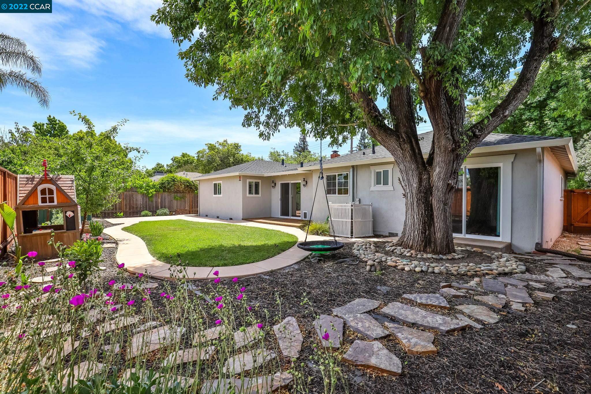 2144 Dena Drive Concord, CA 94519 - Photo 16 of 27 a view of a house with a backyard and a tree