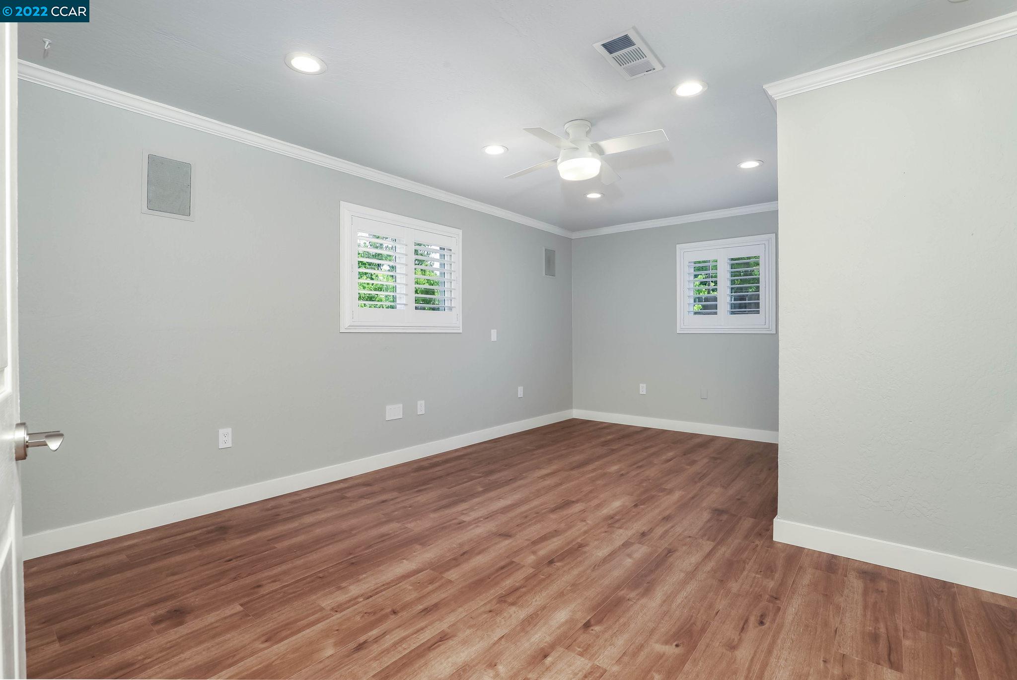 2144 Dena Drive Concord, CA 94519 - Photo 9 of 27 an empty room with wooden floor and windows