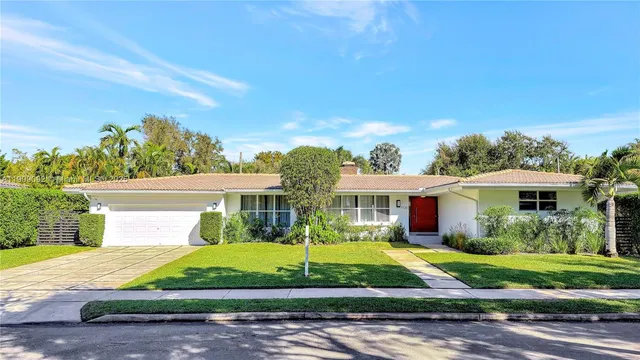 a front view of a house with garden