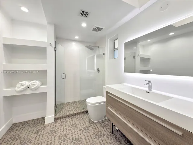 a bathroom with a white tub shower and toilet