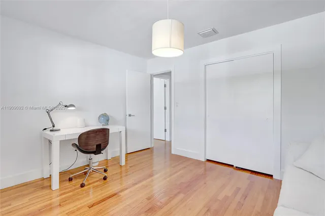 a bedroom with a bed and a cabinet