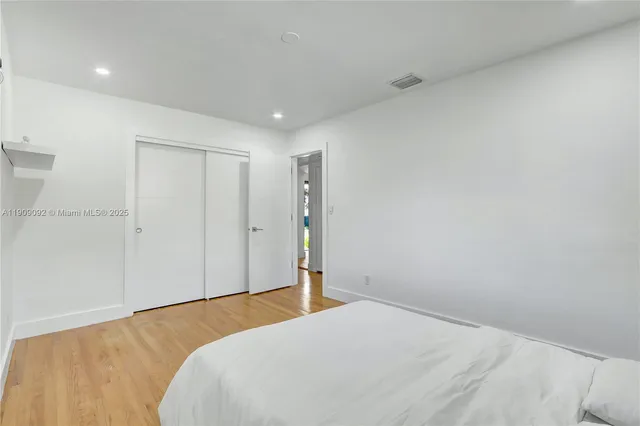 a bedroom with a bed and dresser