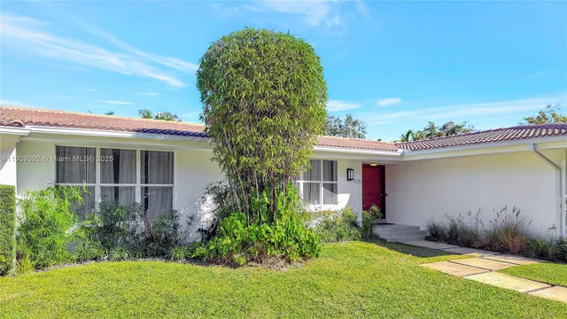 a view of a house with a yard and a fountain