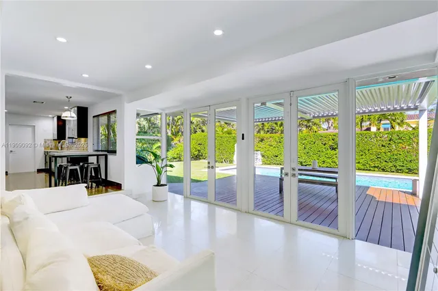 a view of a living room and floor to ceiling window or kitchen