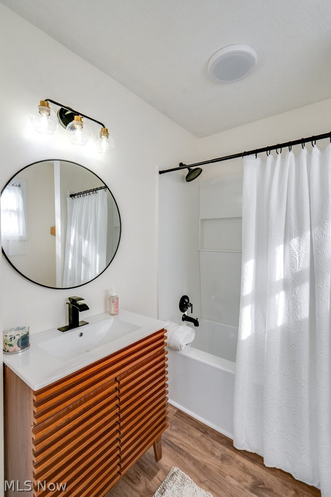 12 South 4th Street Rittman, OH 44270 - Photo 27 of 48 Bathroom featuring light wood-style flooring, vanity, and shower / bath combo
