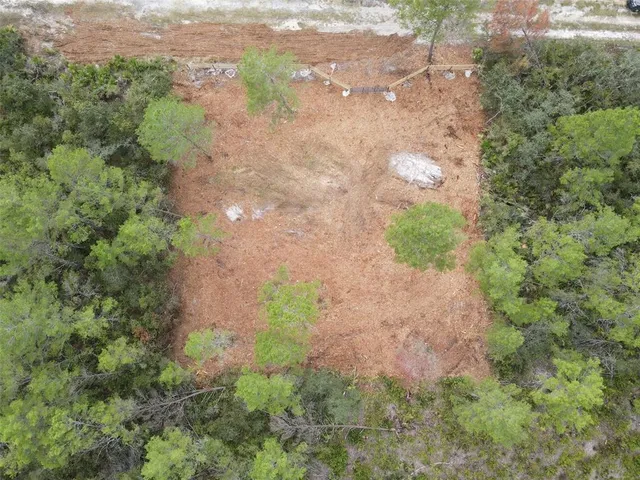 a backyard of a house with a yard and outdoor seating