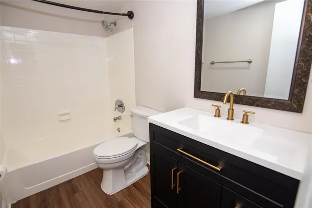 a bathroom with a sink a toilet a shower and a mirror