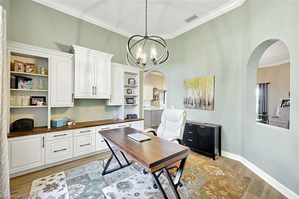2143 Grove Drive Naples, FL 34120 - Photo 12 of 35 a view of a kitchen area with furniture and wooden floor