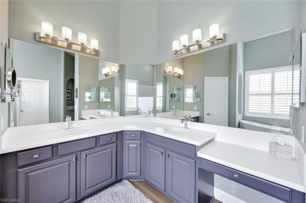 2143 Grove Drive Naples, FL 34120 - Photo 16 of 35 a spacious bathroom with a sink double vanity granite and a large mirror
