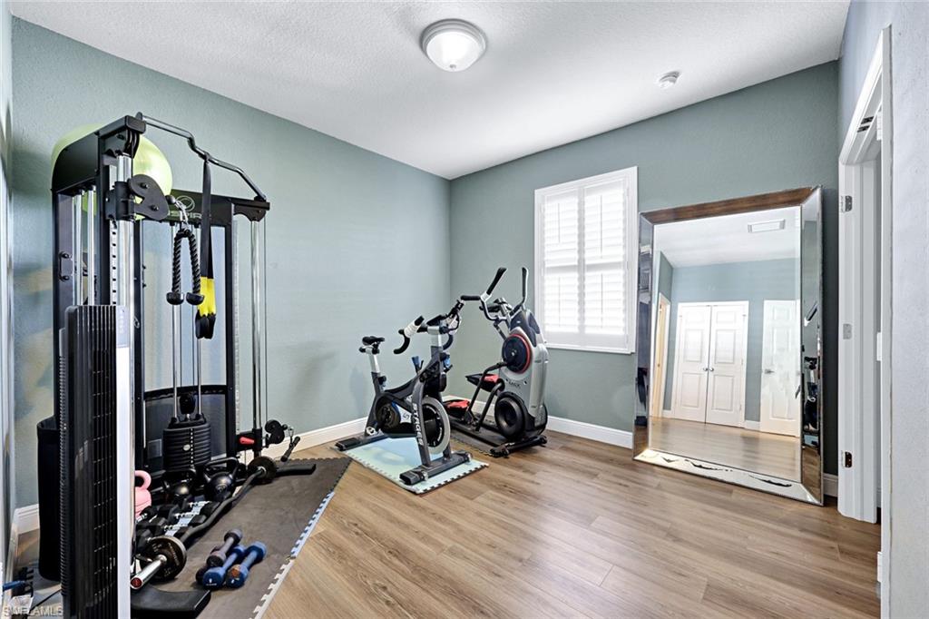 2143 Grove Drive Naples, FL 34120 - Photo 19 of 37 Guest Bedroom 1 is being used as a Workout room with light wood-style floors