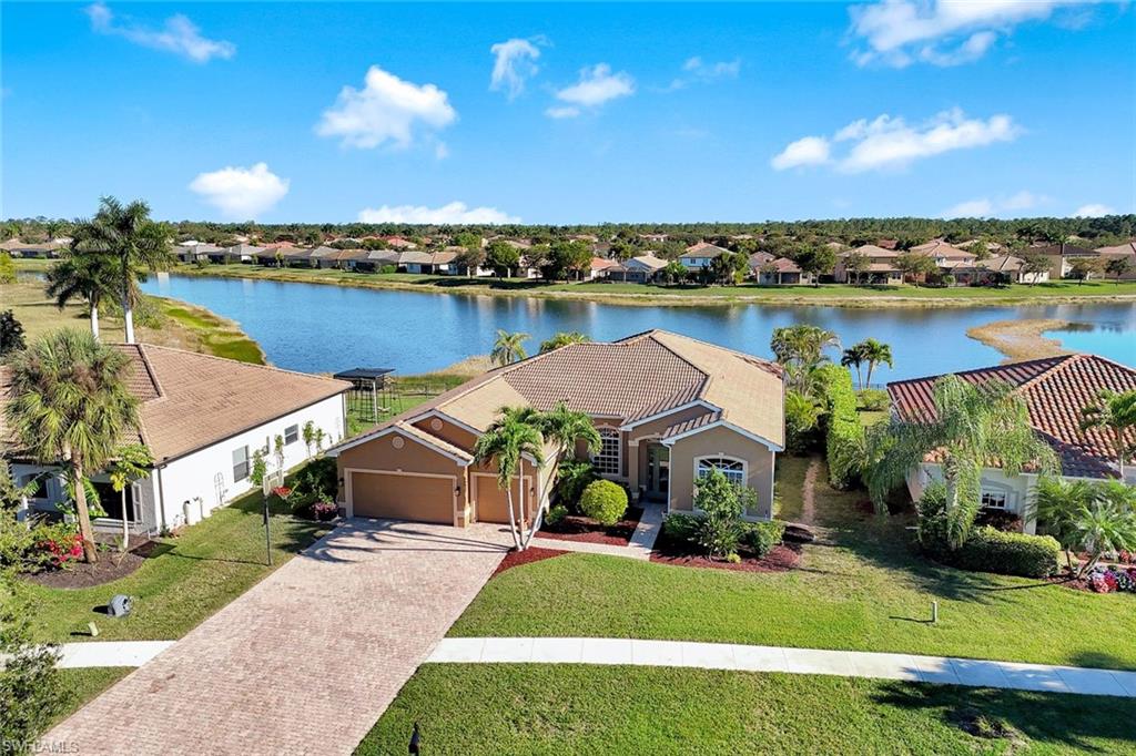 2143 Grove Drive Naples, FL 34120 - Photo 2 of 35 an aerial view of a house with a garden and lake view
