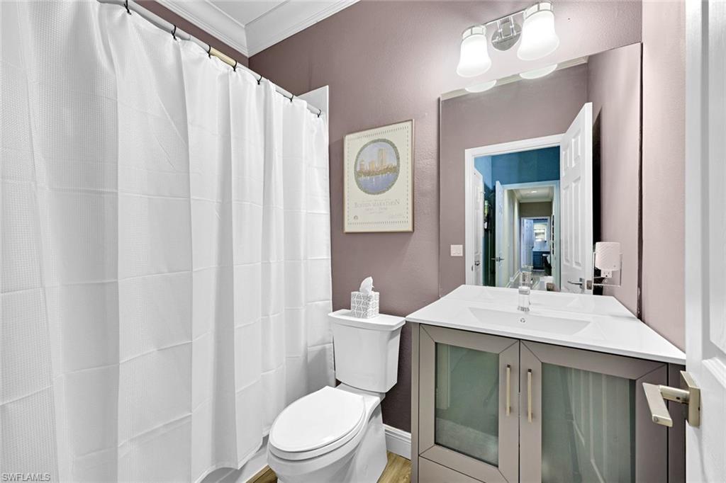 2143 Grove Drive Naples, FL 34120 - Photo 20 of 37 Full bath with a shower with curtain, vanity, and crown molding