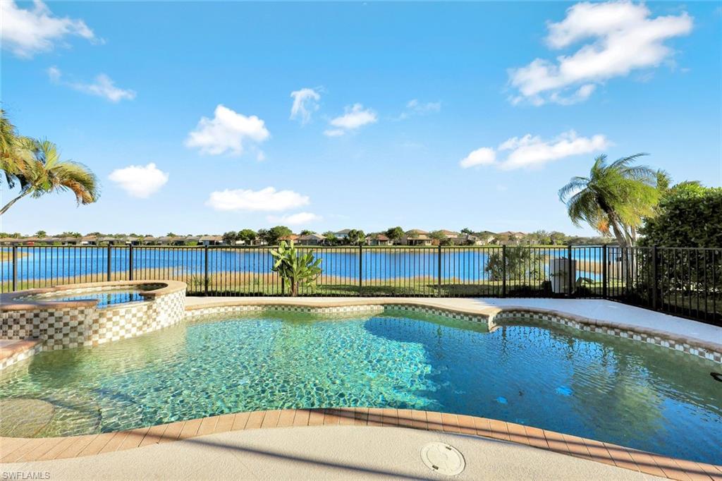 2143 Grove Drive Naples, FL 34120 - Photo 28 of 37 View of swimming pool featuring a pool with connected hot tub and a water view