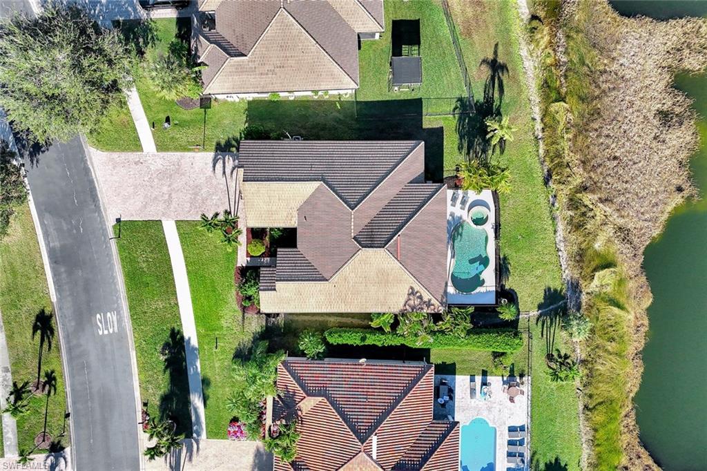 2143 Grove Drive Naples, FL 34120 - Photo 29 of 35 an aerial view of a house with a garden and trees