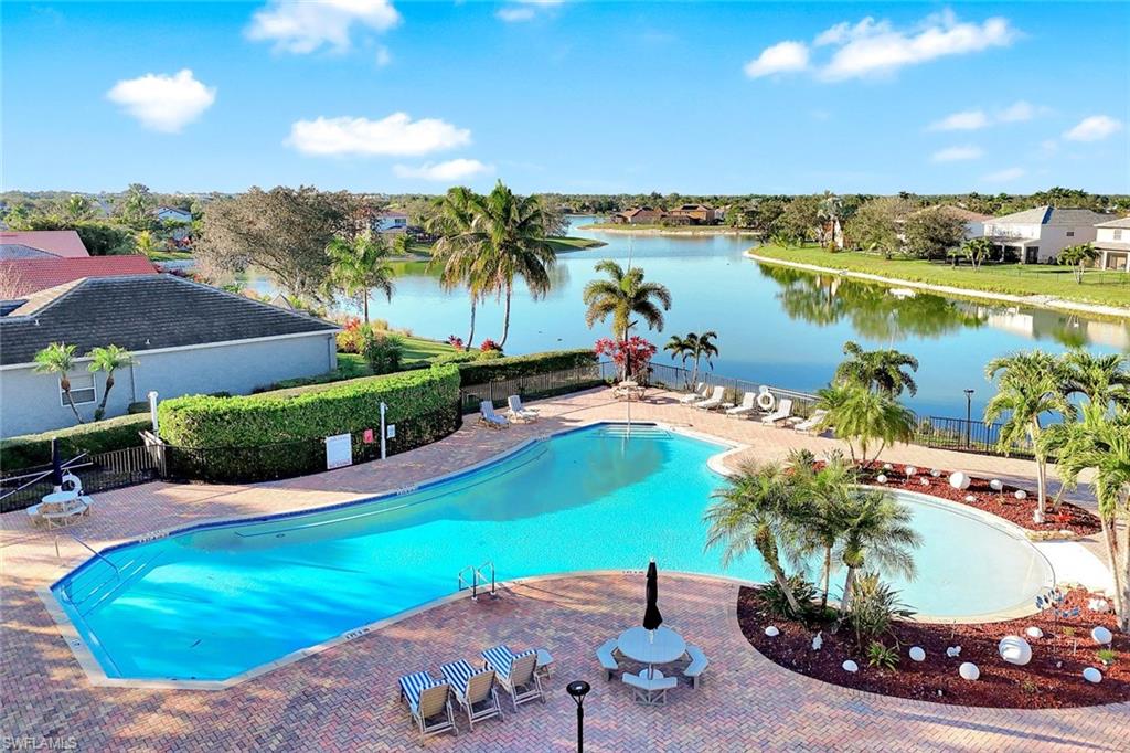 2143 Grove Drive Naples, FL 34120 - Photo 34 of 37 Community pool featuring a patio and a water view