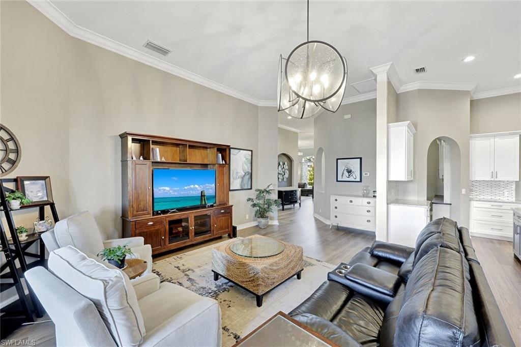 2143 Grove Drive Naples, FL 34120 - Photo 5 of 35 a living room with furniture a rug and a flat screen tv