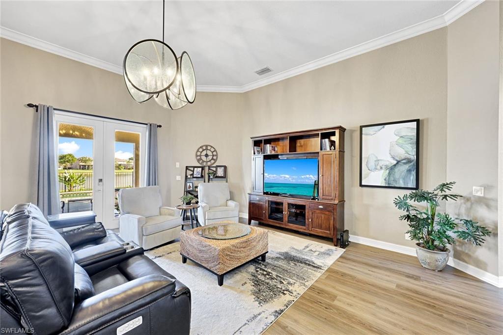2143 Grove Drive Naples, FL 34120 - Photo 6 of 35 a living room with furniture and a flat screen tv