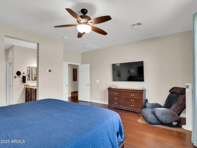 a bedroom with a bed and a television