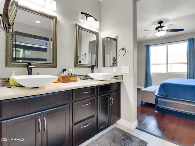 a bathroom with a double vanity sink and a mirror