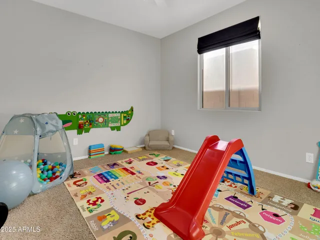 a kids bedroom with a bed and a window