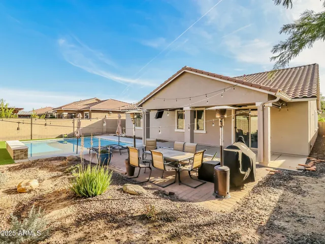 a view of a patio with couches chairs and potted plants