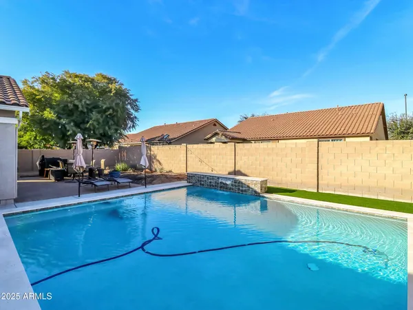 a view of a backyard with a swimming pool