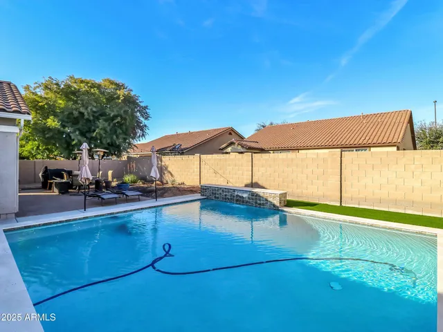 a view of a backyard with a swimming pool