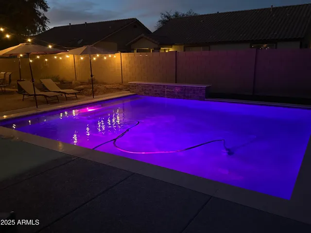 a view of a patio with table and chairs under an umbrella