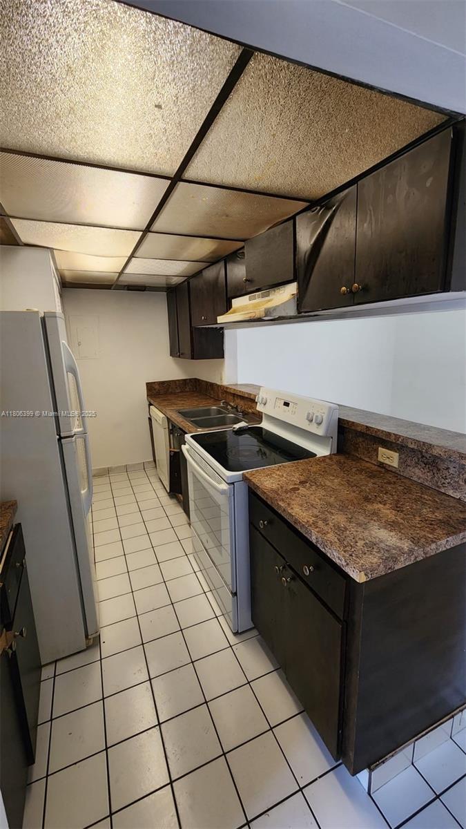 4425 Treehouse Lane, Unit B Tamarac, FL 33319 - Photo 12 of 19 a kitchen with a sink and cabinets