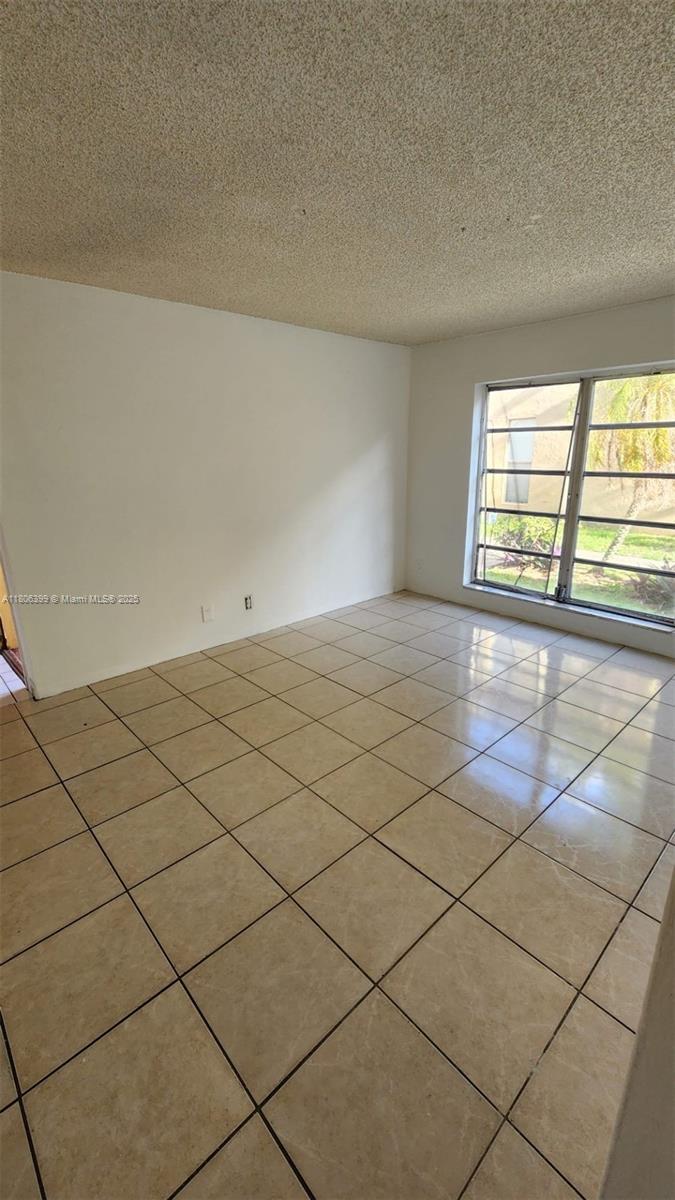 4425 Treehouse Lane, Unit B Tamarac, FL 33319 - Photo 16 of 19 a view of an empty room and a window