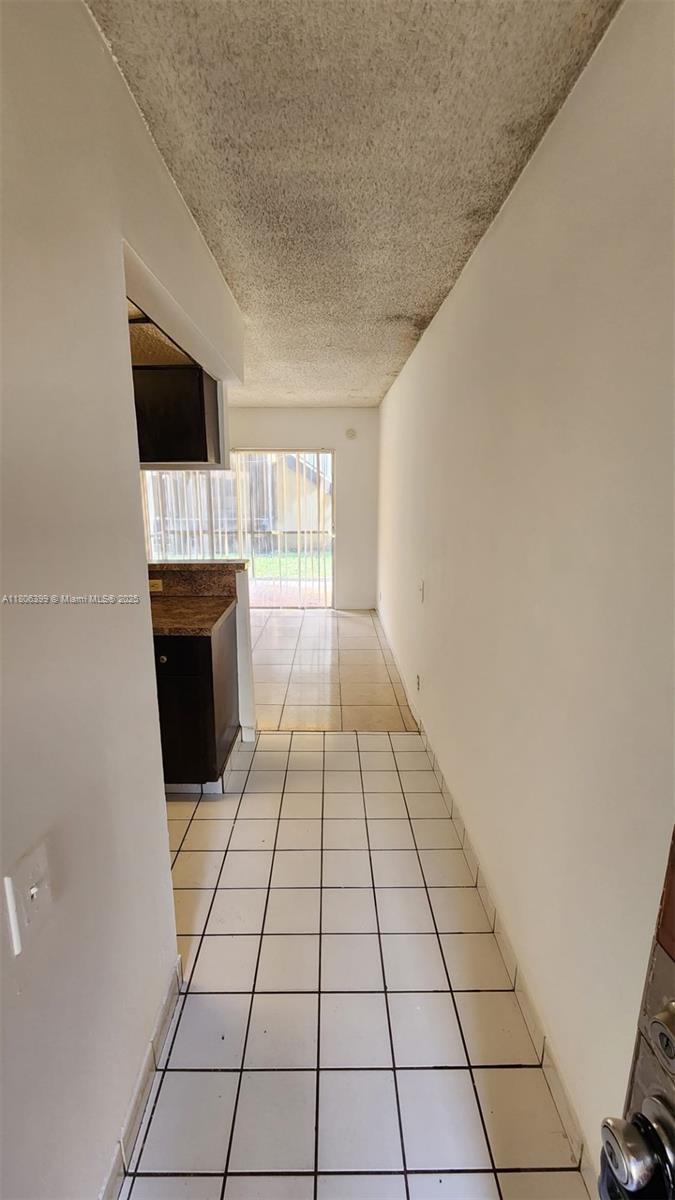 4425 Treehouse Lane, Unit B Tamarac, FL 33319 - Photo 19 of 19 a view of empty room with a fireplace and windows