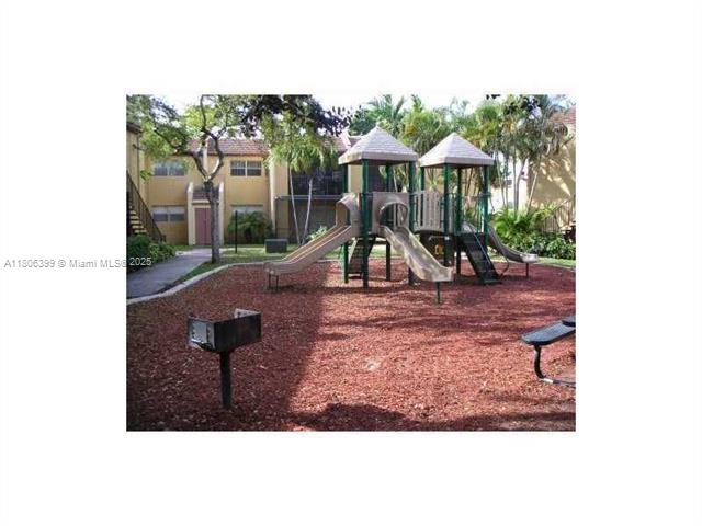 4425 Treehouse Lane, Unit B Tamarac, FL 33319 - Photo 5 of 19 a view of a house with a yard