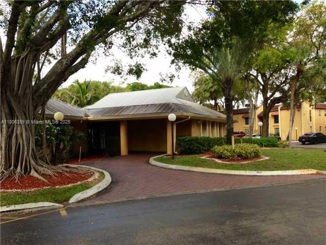 4425 Treehouse Lane, Unit B Tamarac, FL 33319 - Photo 7 of 19 a front view of a house with a yard