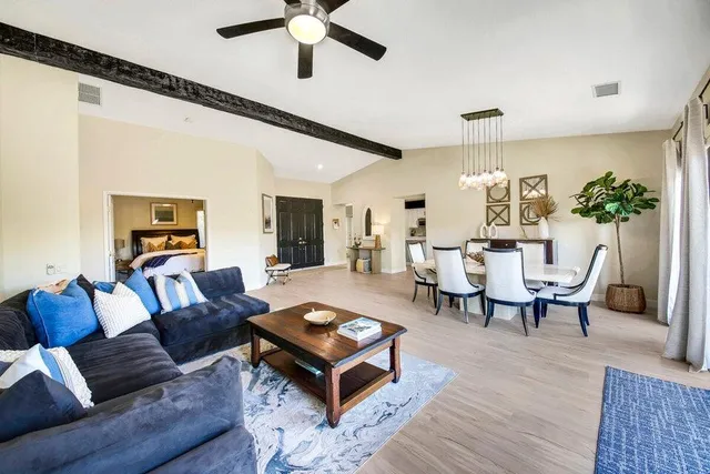 a living room with furniture and a wooden floor