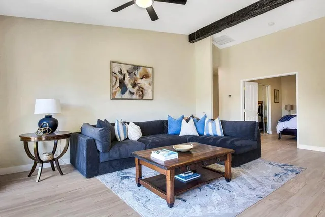 a living room with furniture and wooden floor