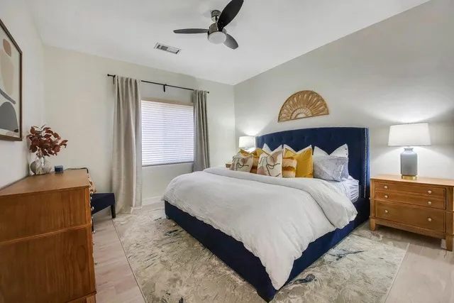 a bedroom with a bed and a potted plant