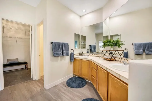a kitchen with stainless steel appliances granite countertop a sink and a refrigerator