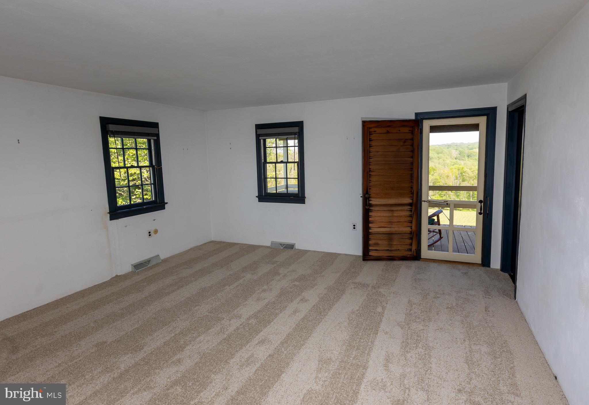1420 Street Road Chester Springs, PA 19425 - Photo 21 of 46 1st Floor Primary Bedroom with Door to Rear Porch