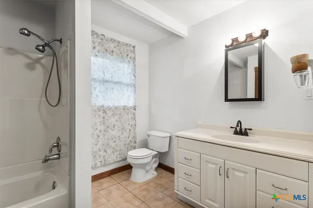 a bathroom with a double vanity sink toilet and shower