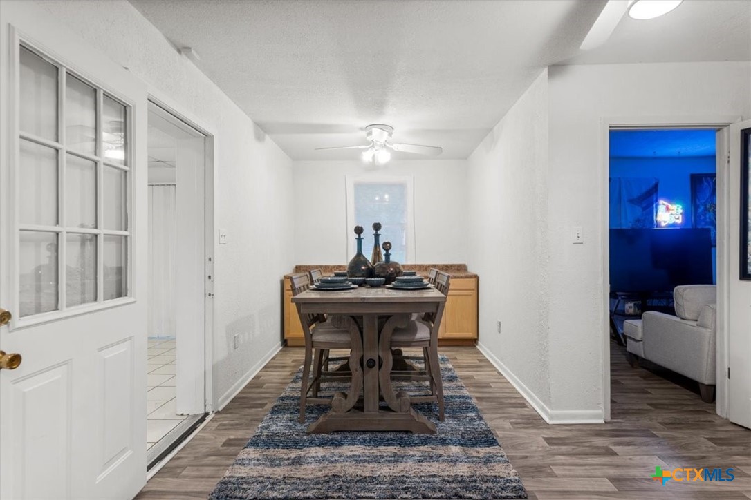 1102 South 5th Street Copperas Cove, TX 76522 - Photo 20 of 40 a dining room with chandelier and wooden floor